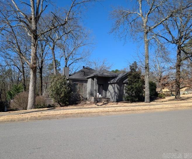 view of front of house with a garage, driveway, and a chimney