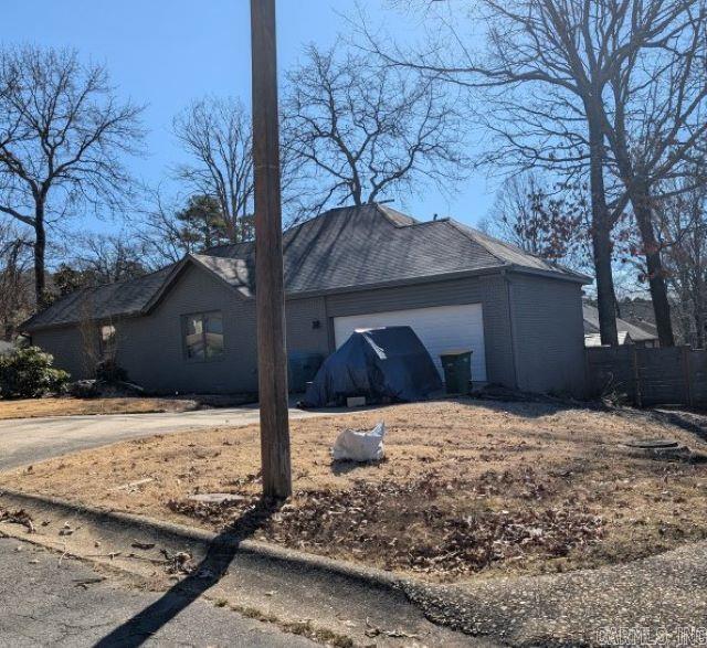 view of side of property with a garage and fence