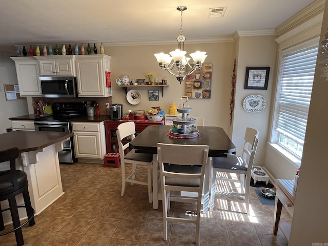 dining room with plenty of natural light, visible vents, and crown molding