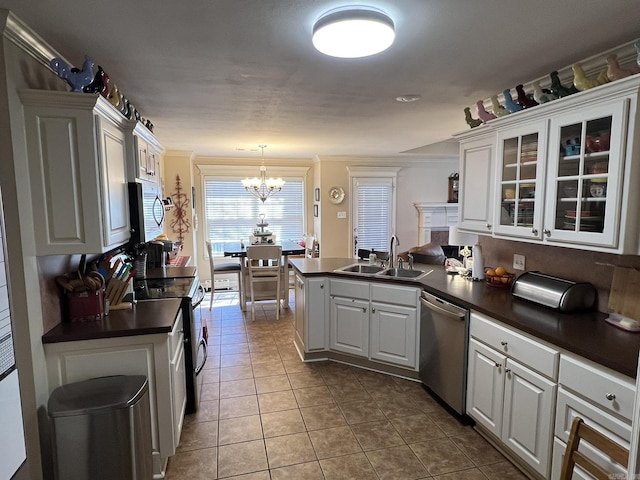 kitchen featuring appliances with stainless steel finishes, dark countertops, and a sink