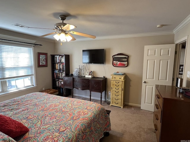 carpeted bedroom featuring a ceiling fan, baseboards, and crown molding