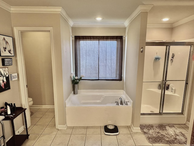 bathroom featuring a garden tub, a stall shower, tile patterned flooring, and toilet