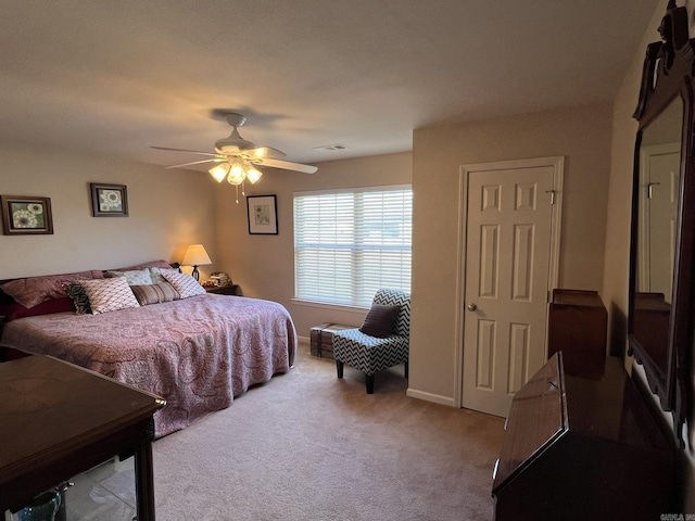 bedroom with carpet, visible vents, baseboards, and a ceiling fan