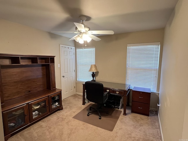 office with ceiling fan, baseboards, and light colored carpet