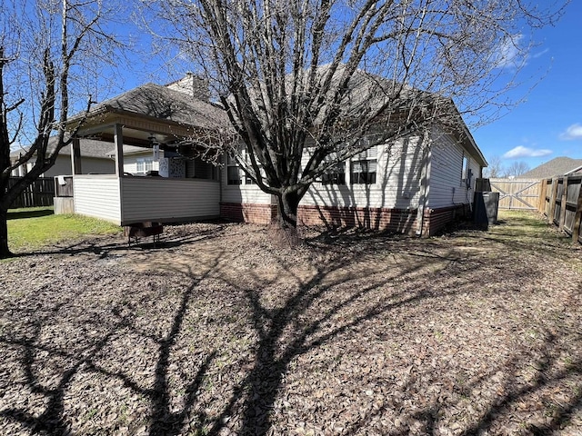 view of side of home with fence