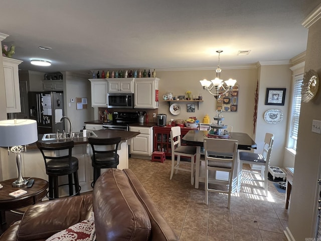 interior space featuring visible vents, white cabinets, black appliances, dark countertops, and crown molding