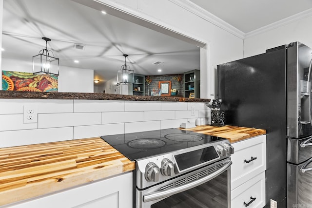 kitchen featuring visible vents, white cabinets, appliances with stainless steel finishes, ornamental molding, and wooden counters