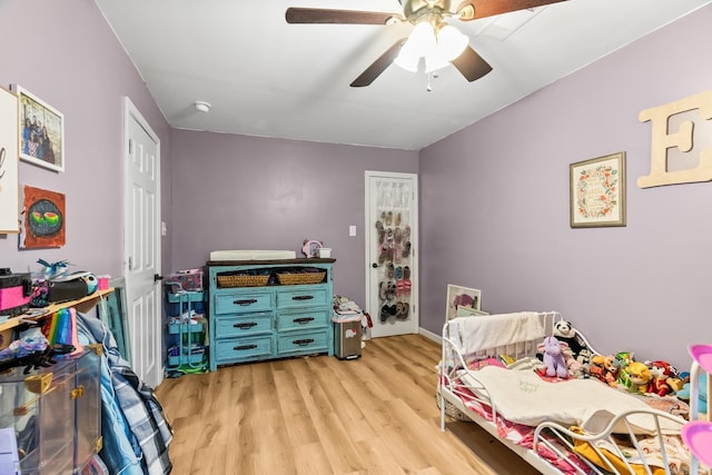 bedroom with light wood-type flooring and ceiling fan