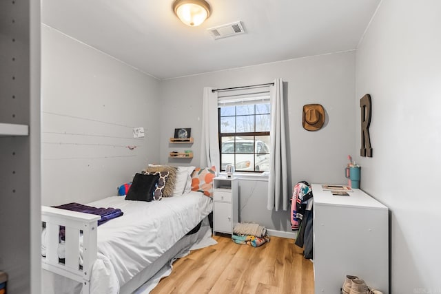 bedroom featuring light wood-style floors and visible vents