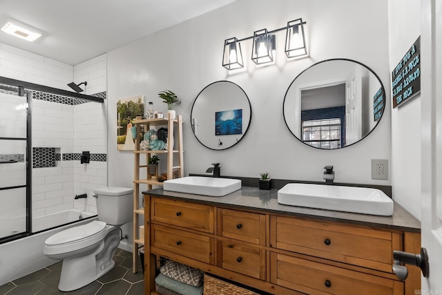 bathroom featuring tile patterned flooring, a sink, toilet, and double vanity