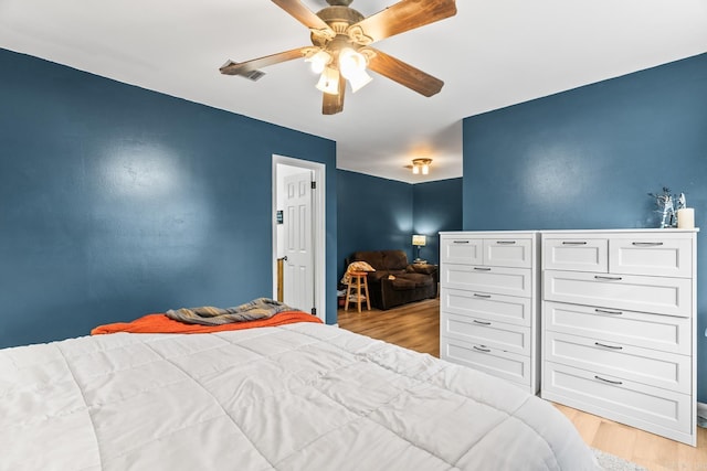 bedroom with light wood-type flooring and a ceiling fan