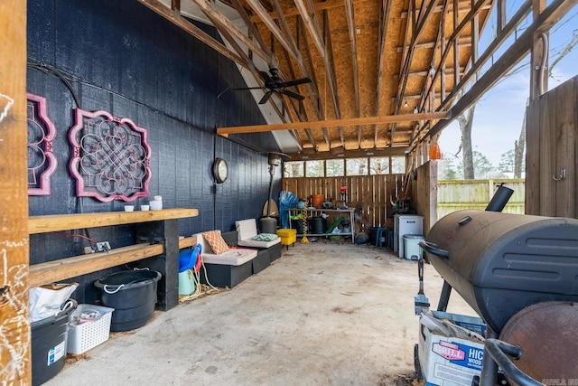 garage featuring fence and a ceiling fan