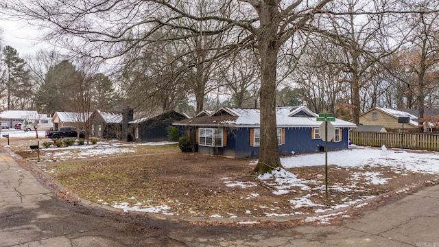 ranch-style house with fence