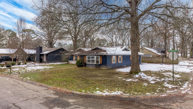 single story home with fence and a chimney