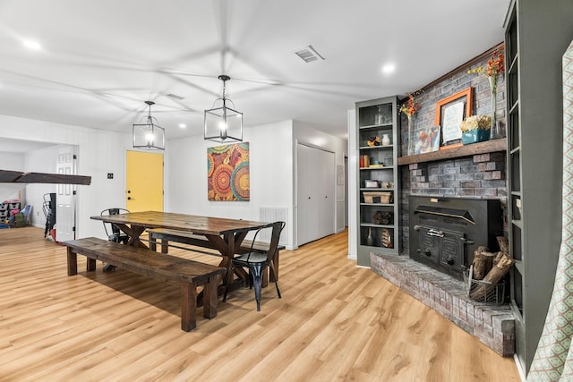 dining area with light wood-type flooring and visible vents