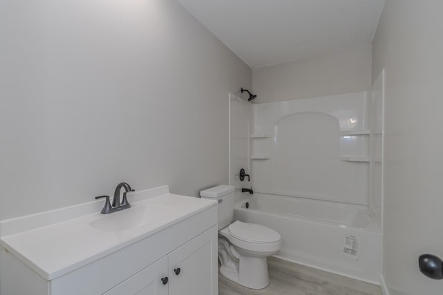 bathroom featuring shower / bathing tub combination, vanity, toilet, and wood finished floors