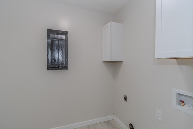 washroom featuring washer hookup, cabinet space, baseboards, and hookup for an electric dryer