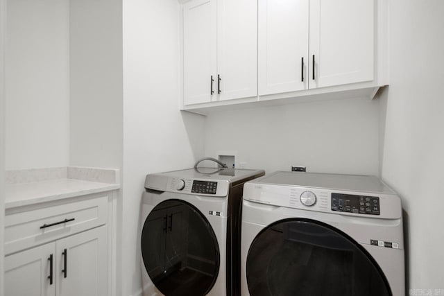 laundry room featuring cabinet space and washer and clothes dryer