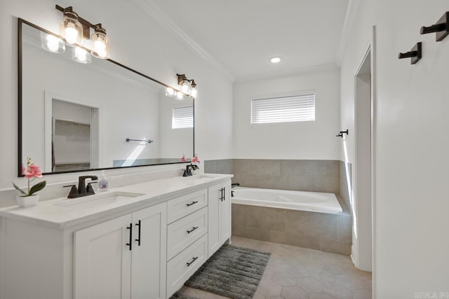 bathroom with a garden tub, ornamental molding, a sink, and tile patterned floors