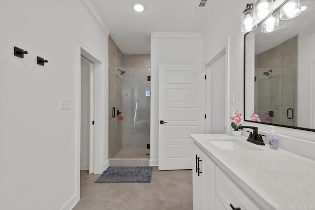 bathroom with ornamental molding, a stall shower, vanity, and baseboards