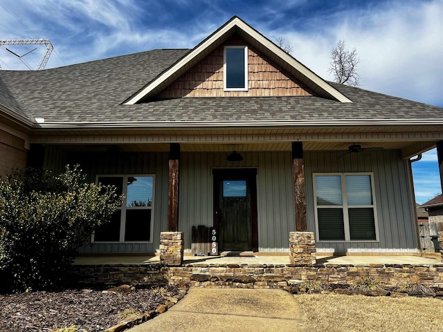 view of front of house featuring a porch, a shingled roof, and board and batten siding