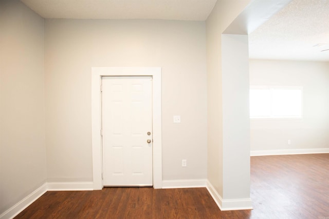 interior space with baseboards and wood finished floors