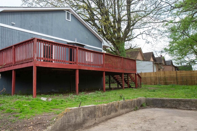 back of house with a yard, fence, a deck, and stairs