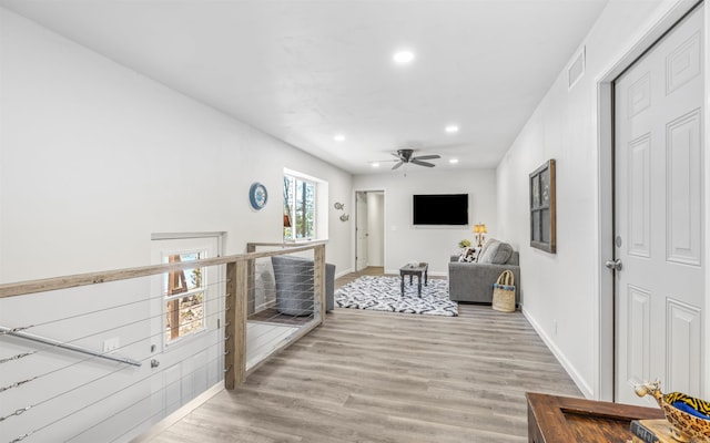 living room with baseboards, visible vents, a ceiling fan, wood finished floors, and recessed lighting