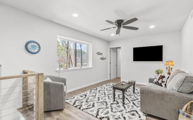 living area with recessed lighting, ceiling fan, baseboards, and wood finished floors