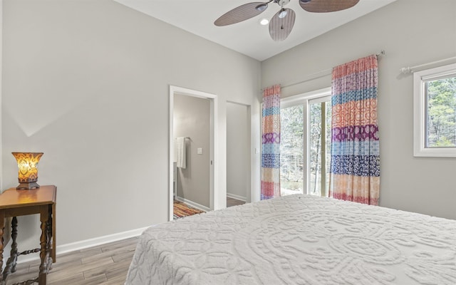 bedroom with a ceiling fan, baseboards, and wood finished floors