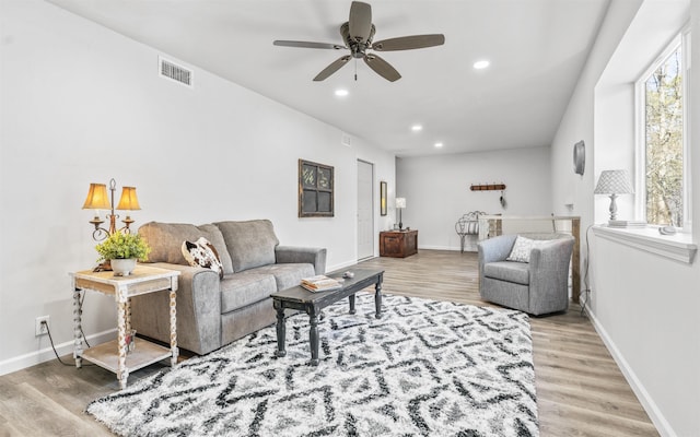 living room featuring wood finished floors, visible vents, and recessed lighting