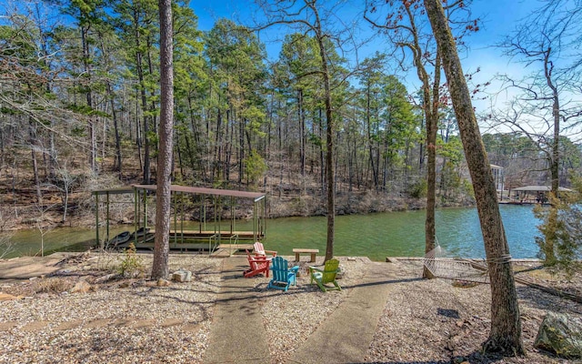 view of yard with a water view and a view of trees