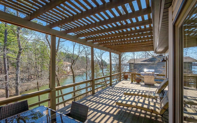 deck featuring outdoor dining area, a water view, and a pergola