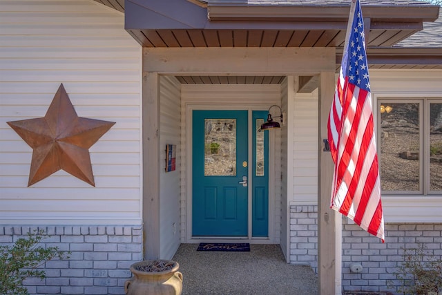 entrance to property with brick siding