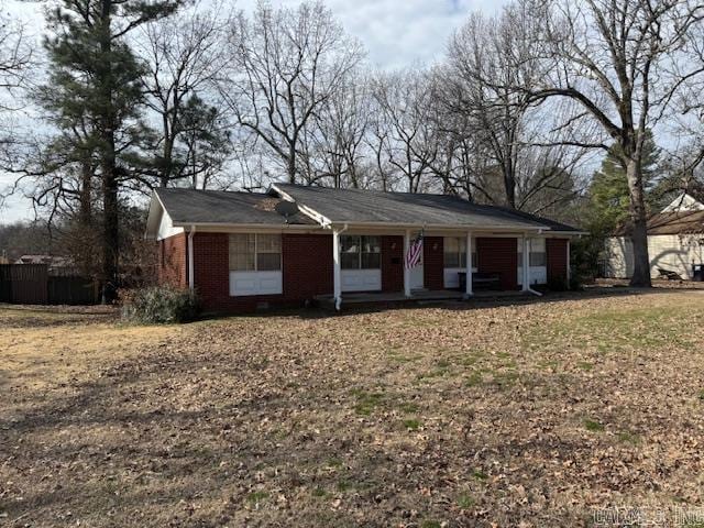 single story home with covered porch and brick siding