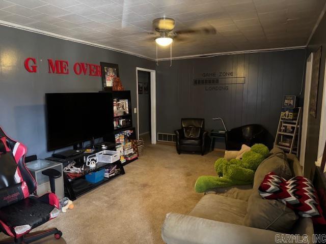 living room featuring carpet floors, visible vents, and crown molding