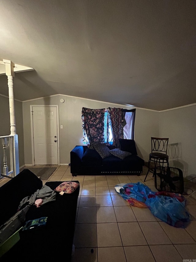 living area featuring lofted ceiling, tile patterned flooring, and ornamental molding