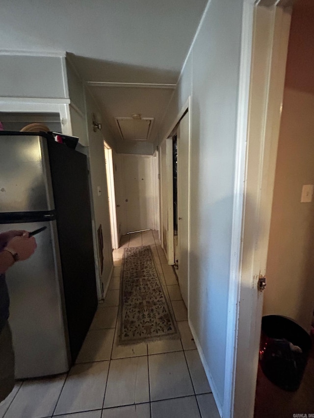 hall featuring light tile patterned flooring