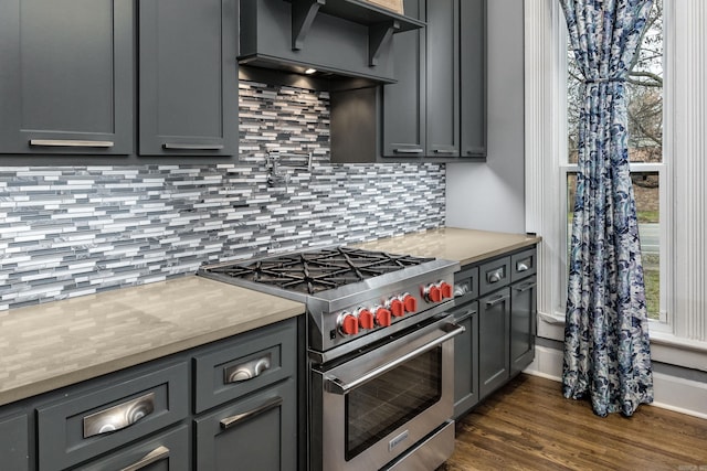 kitchen with light countertops, premium range hood, gray cabinets, and high end range