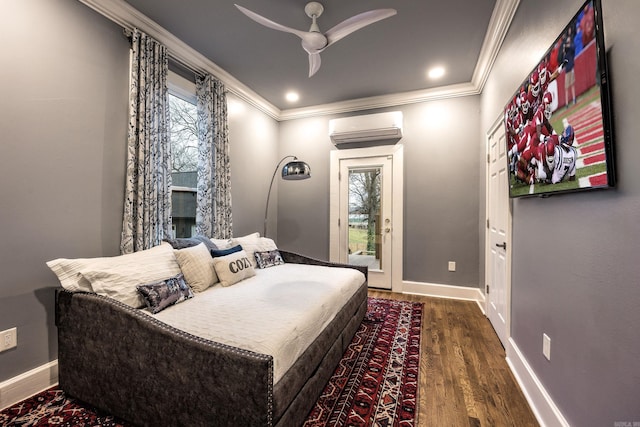 bedroom with baseboards, wood finished floors, crown molding, and a wall mounted AC