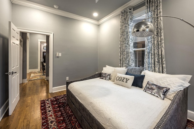 bedroom featuring recessed lighting, crown molding, baseboards, and wood finished floors