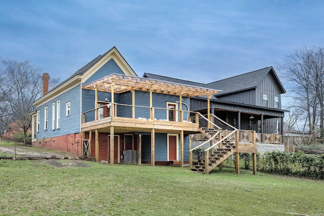 back of house with a yard, central air condition unit, stairway, board and batten siding, and a wooden deck