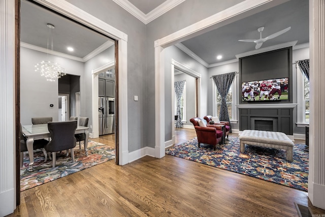 interior space featuring crown molding, a fireplace, and wood finished floors