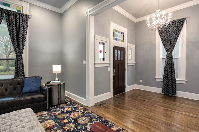 entryway featuring ornamental molding, visible vents, baseboards, and wood finished floors