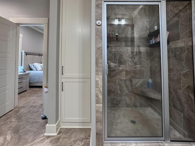 bathroom with lofted ceiling, a shower stall, and ensuite bathroom