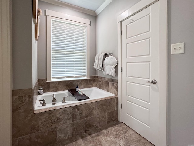 bathroom featuring a garden tub, ornamental molding, and tile patterned floors