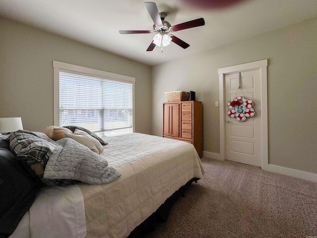 bedroom with baseboards, ceiling fan, and light colored carpet