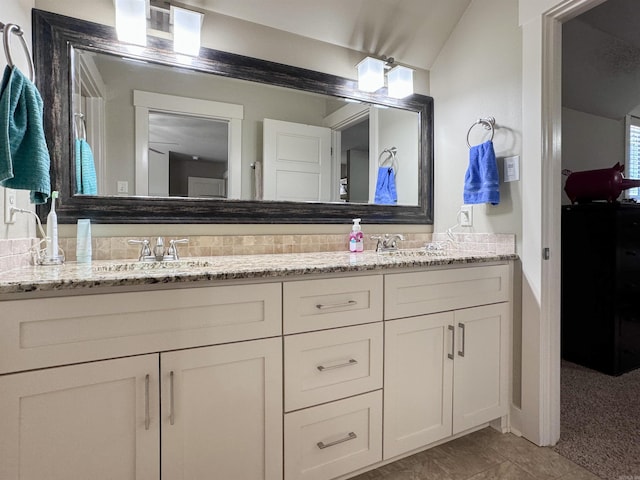 bathroom featuring double vanity and a sink