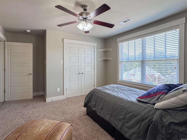 bedroom with carpet, a closet, visible vents, ceiling fan, and baseboards