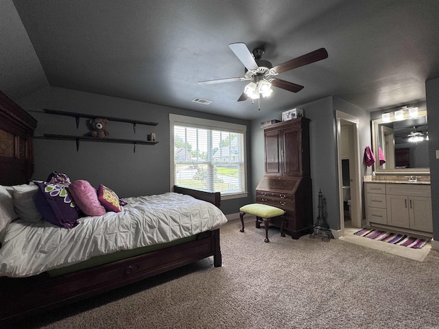 bedroom featuring ceiling fan, lofted ceiling, a sink, carpet flooring, and visible vents